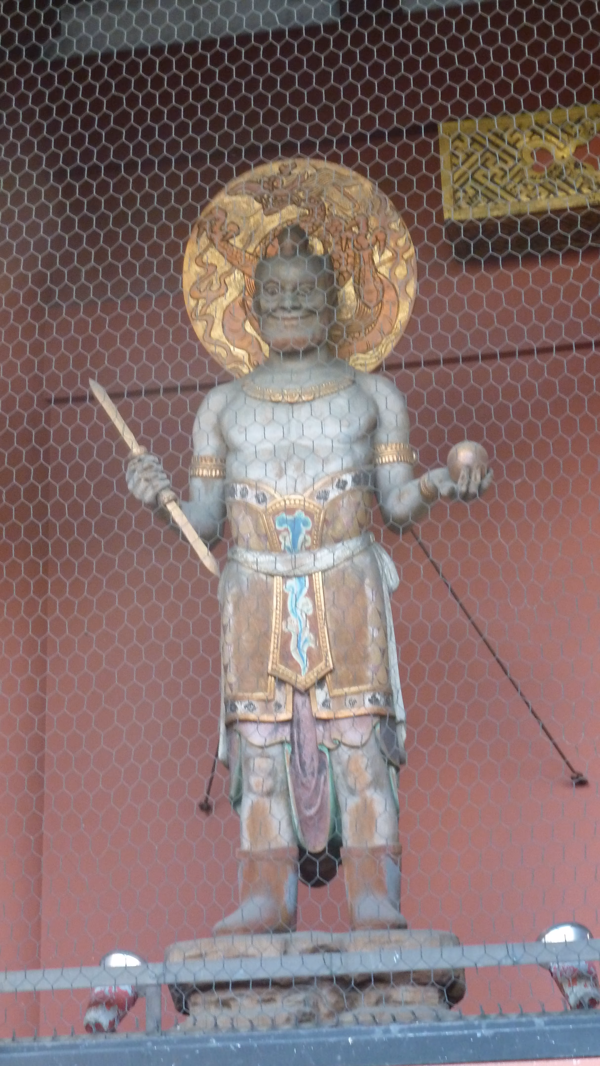 A second guardian statue at Hōzōmon, on the opposite side of the gate, also behind wire mesh
