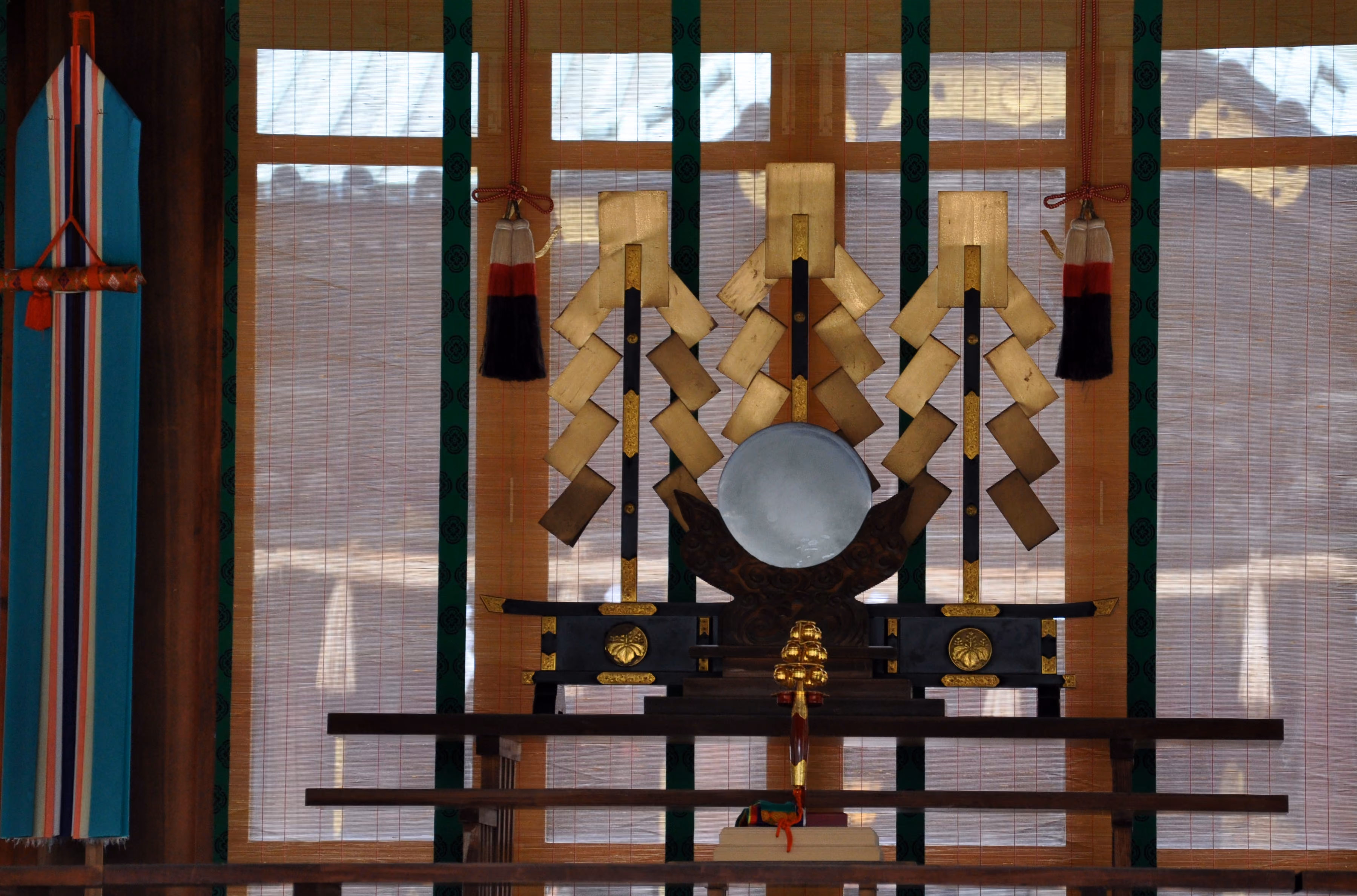 Sacred paper streamers (shide) and a drum arranged on an altar inside Mishima Taisha