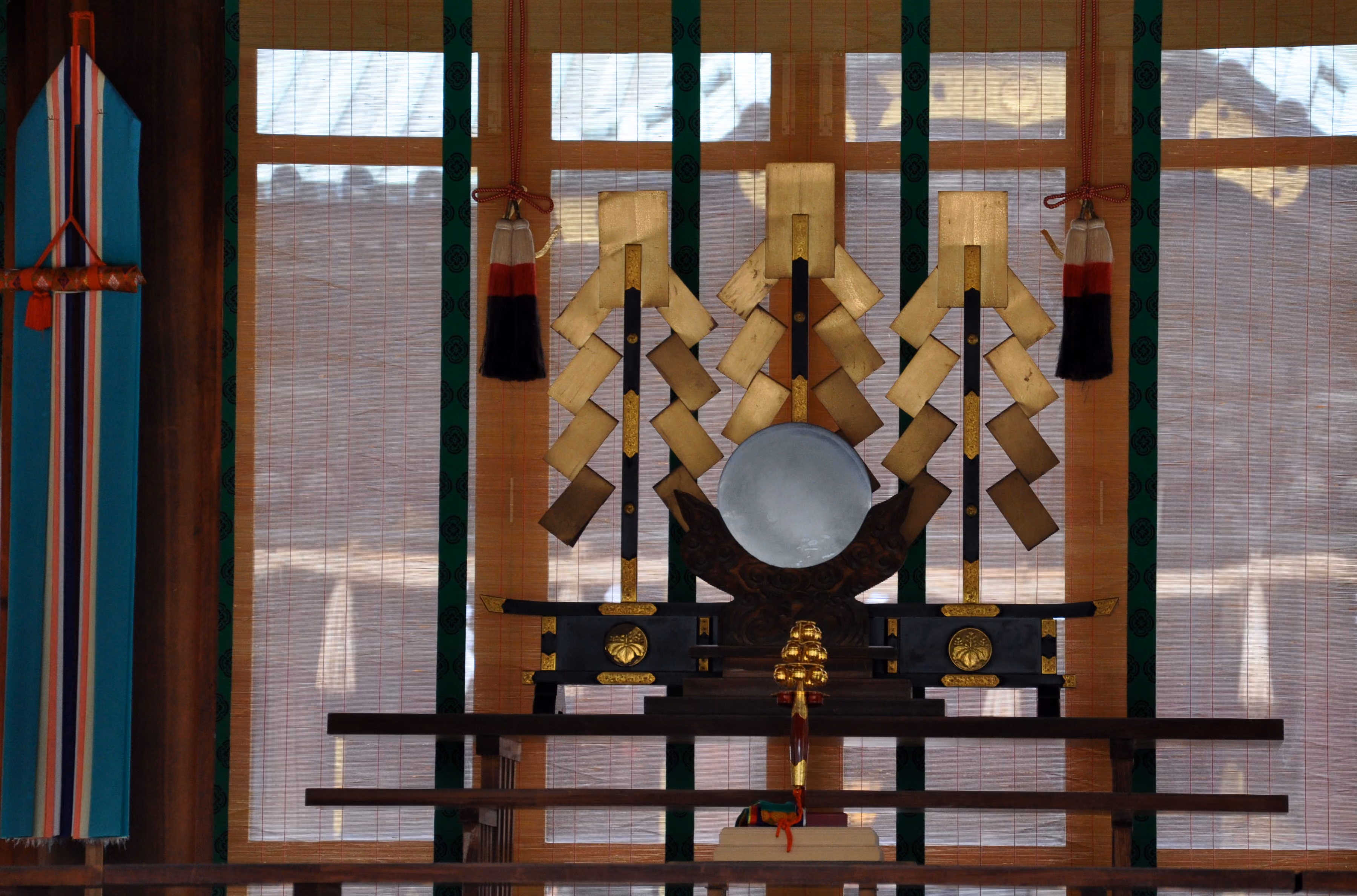 Sacred paper streamers (shide) and a drum arranged on an altar inside Mishima Taisha