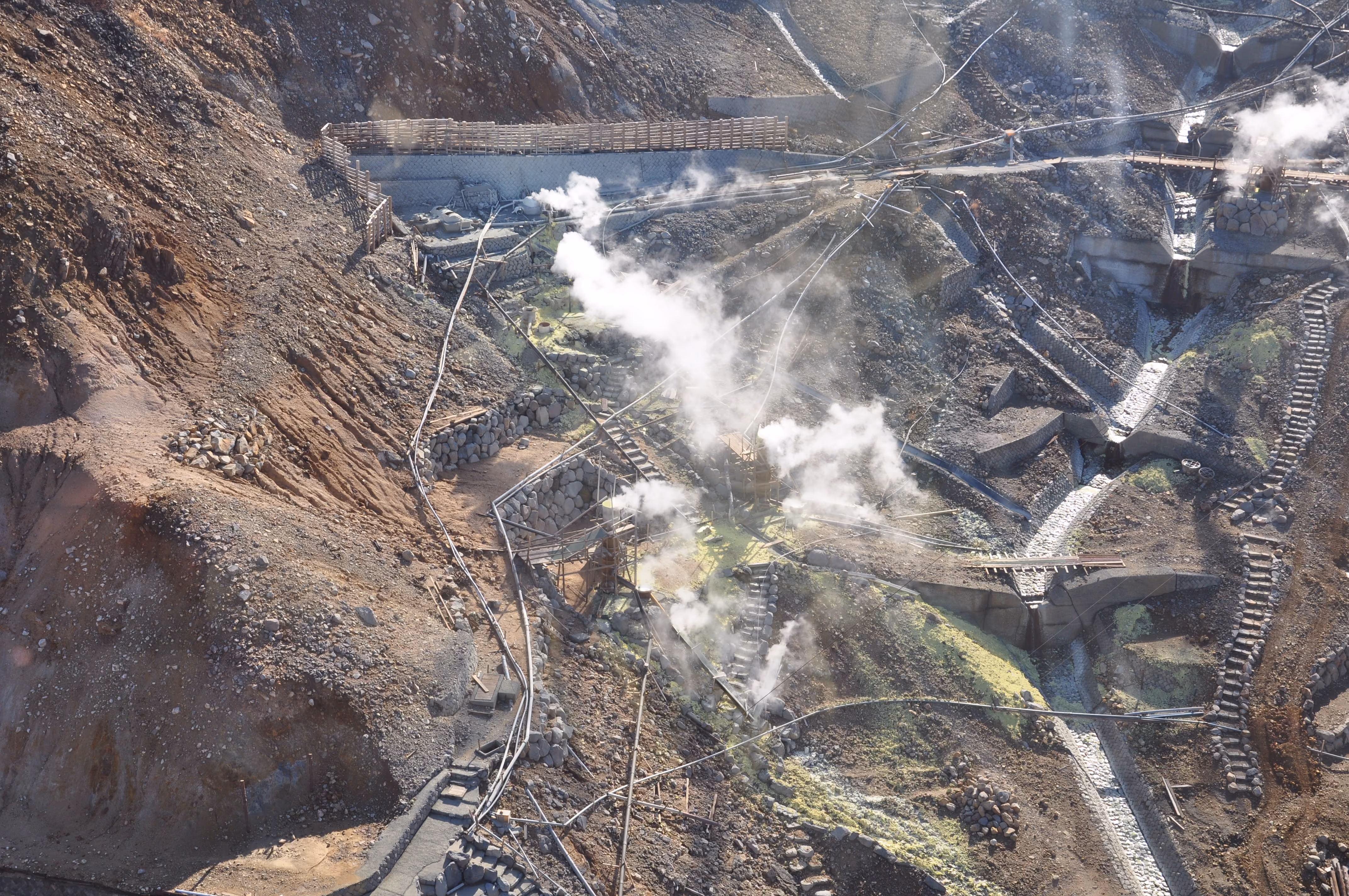 Steam vents and walkways on the volcanic valley floor at Owakudani